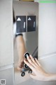 A woman's hand is pressing a button on an elevator.