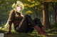 Anime girl sitting on the ground in the woods.