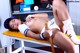 A woman in a baseball uniform is laying on a bench.