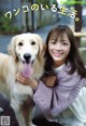 A woman is hugging a dog on the street.