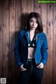 A woman in a denim jacket posing for a picture.