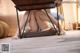 A woman sitting under a table with her legs crossed.