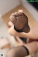 A close up of a woman's feet in black stockings.