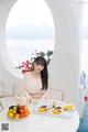 A woman sitting at a table with a tray of food.