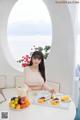 A woman sitting at a table with a tray of food.