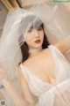 a woman wearing a white lingerie and a veil