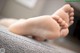 A close up of a baby's feet on a couch.